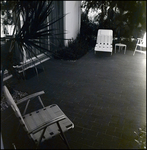 Folding Lawn Chairs on Outdoor Patio By Sliding Glass Door in Tampa, Florida, A by Skip Gandy