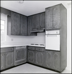 Kitchen with Frigidaire Stove, Frigidaire Dishwasher, and Wooden Cupboards with Crystal Knobs, C by Skip Gandy