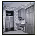 Rotary Dial Phone Sits on Floating Desk Next to Saloon Doors Entrance in Home in Tampa, Florida, B by Skip Gandy