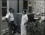 Two Men Chat Behind J.C. Pressly and Co. Building During Break in St. Petersburg, Florida by Skip Gandy