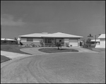 Single-Story House with Curved Driveway by George Skip Gandy IV