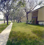 Sidewalk and Exterior of Brookgreen Apartments, Clearwater, Florida, A by George Skip Gandy IV