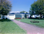 Front View of Home with Landscaping by George Skip Gandy IV