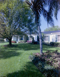 Side View of Home with Landscaping by George Skip Gandy IV