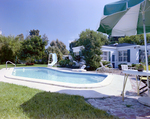 Backyard Pool Area with Patio, A by George Skip Gandy IV