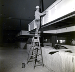 Side View of Workers Assembling Large Interior Framework, A by George Skip Gandy IV