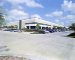 White Commercial Building with Parking Lot by George Skip Gandy IV