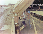 Workers Using Power Tools on Timber, L by George Skip Gandy IV