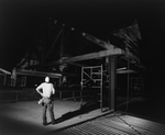 Construction Supervisor Observing Framework at Night, A by George Skip Gandy IV