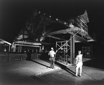 Construction Team Observing Wooden Framework at Night, A by George Skip Gandy IV