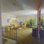 Man and Woman Sitting in Living Room at Mariners Pass Condominiums in St. Petersburg, B by George Skip Gandy IV