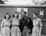 Three nurses with man in bomber jacket