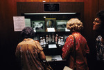 Visitors looking at Gordon Keller school of nursing display in USF library