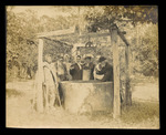 Lue Gim Gong and Visitors Using Well