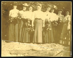 Group of Women Holding Small Branches of Oranges