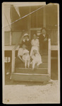 Family Sitting on Steps of Home