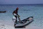 Man Stands Near Boat on Beach of Bolanos Cay, Island in Cayos Cochinos, Honduras