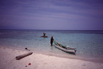 Two Fishermen Return with Boats to Bolanos Cay in Cayos Cochinos, Honduras by John C. Ogden