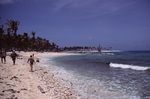 Beachgoers Walk Down Shore with Lighthouse in Background, Turneffe Atoll, Belize by John C. Ogden and Nancy B. Ogden