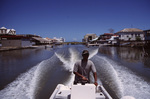 Man Drives Boat Down Canal in Belize by John C. Ogden and Nancy B. Ogden