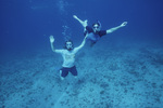 Two Snorkelers Pose Together Underwater in Cut in San Pedro, Belize