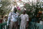 Couple Poses on Patio Covered in Potted Plants in Anguilla by John C. Ogden