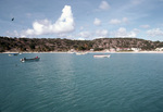 Boats Linger near Shore on Road Bay in Anguilla by John C. Ogden