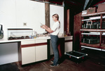 Researcher Preparing Equipment in Laboratory by John C. Ogden