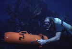 SCUBA diver using a sea scooter propulsion device