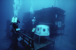SCUBA diver swimming near Aquarius Reef Base by John C. Ogden