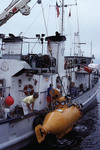 Small submarine being lowered into the water from the Research Vessel "Suncoaster" [2]