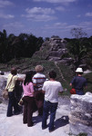 Group of people viewing a Mayan stone pyramid at Altun Ha, Belize by John C. Ogden