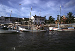 Harbor of Belize City with a courthouse in the background by John C. Ogden