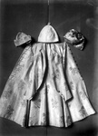 A Silk embroidered frockcoat, daisy design, and three caps