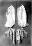 A Vest with small flowers, a vest with poppy flowers with leaves and lace cut work and a collar cape with an embroidered design