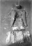 A Woman's cap, a quilted jacket, a flowered bodice and flowered waist sleeves