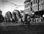 Children Pull a Dragon Balloon During a Parade