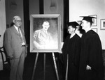 Graduates at Mr. Rawlings Portrait at the Rawlings Reading Room at the University of Tampa Library