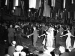 Large Celebration Inside a Building with United States Flags Hanging from the Ceiling by Robertson and Fresh