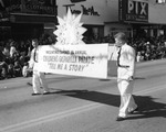 Two Boys Carrying a Sign During the Children's Gasparilla Parade