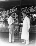 [A man handing an employee a check in front of a grocery store] by Robertson and Fresh