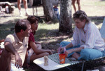 Three People Sit on Grass at Shangri-La Retreat by University of South Florida