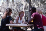Four People Chat at Picnic Table at Shangri-La by University of South Florida