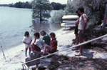 People Stand by Shore of Lake Thonotosassa with Fishing Rods by University of South Florida