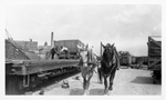 Unloading Railroad Cars onto Horse-Drawn Carts by Unknown