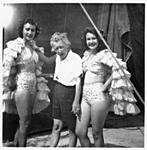 Two Chorus Girls in Costume with a Smoking Woman