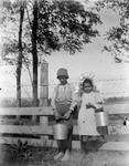 African American boy and girl holding milking pails by Archibald Clarke Slaymaker