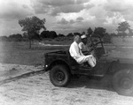 John Allen riding in a jeep on the land that would become USF by University of South Florida