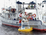 College of Marine Science researchers setting up ocean-atmosphere buoy