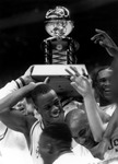 USF men's basketball team with Sun Belt Conference championship trophy by University of South Florida